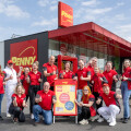 The PENNY management team in front of the store in Feldbach.