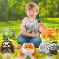 A child sitting on grass in a park, smiling and holding a plush elephant. Surrounding him are plush toys of a turtle, giraffe, sloth, tiger, and zebra. Sunlight filters through the trees in the background.