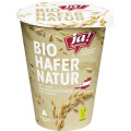 A container of "Ja! Natürlich" Bio Hafer Natur, featuring images of oats and a vegan label. The design highlights organic Austrian origin oats with no added sugar.
