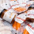 Packets of sausages and jars of sauce with labels featuring cartoon chefs arranged together.